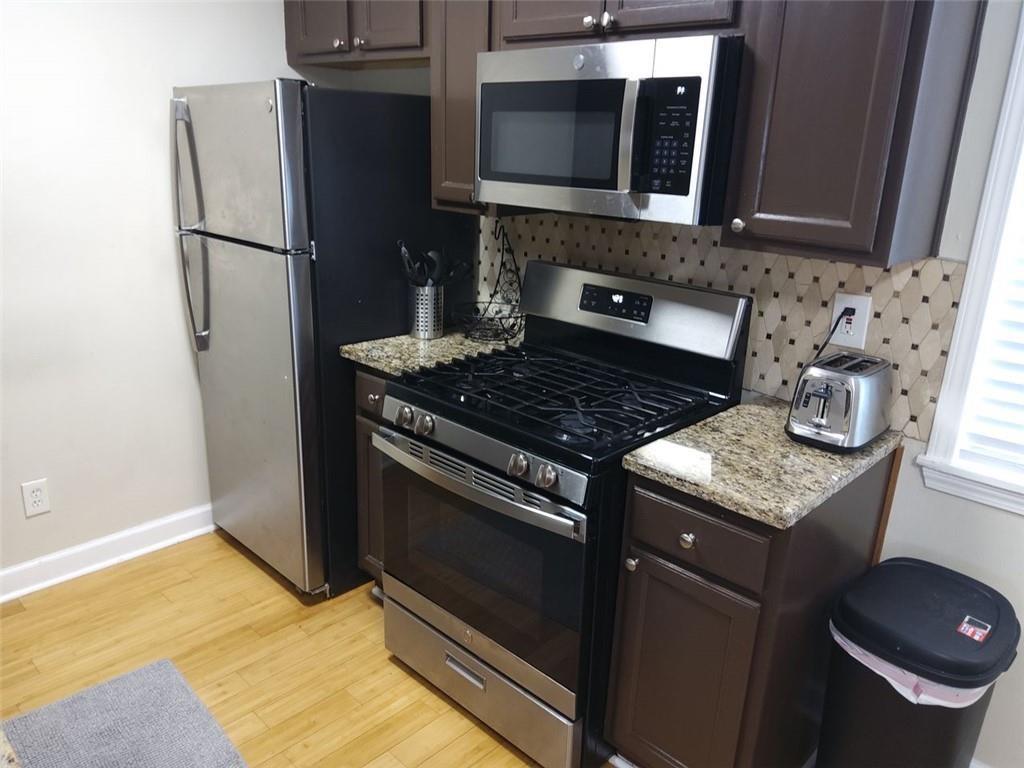 405 Fairburn Road Southwest, Unit 21 Atlanta, GA 30331 - Photo 5 of 16 a kitchen with a stove and a microwave