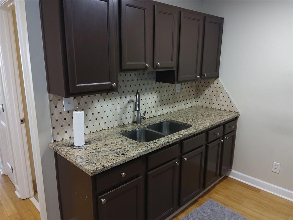 405 Fairburn Road Southwest, Unit 21 Atlanta, GA 30331 - Photo 6 of 16 a kitchen with wooden cabinets and a sink