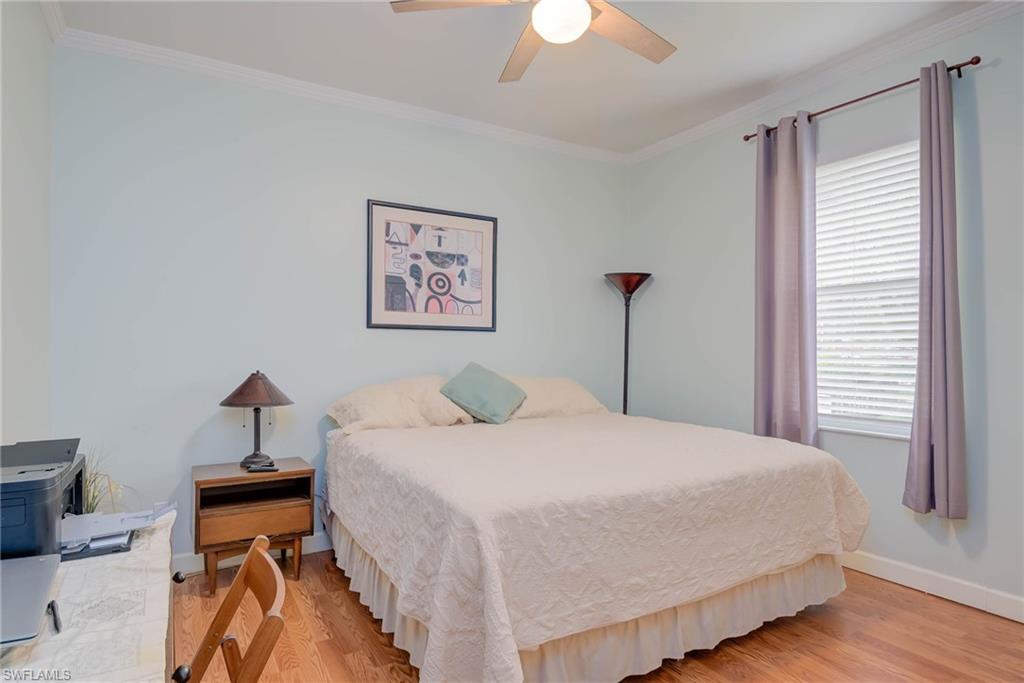 18370 Tulip Road Fort Myers, FL 33967 - Photo 17 of 30 a bedroom with a bed and a chandelier