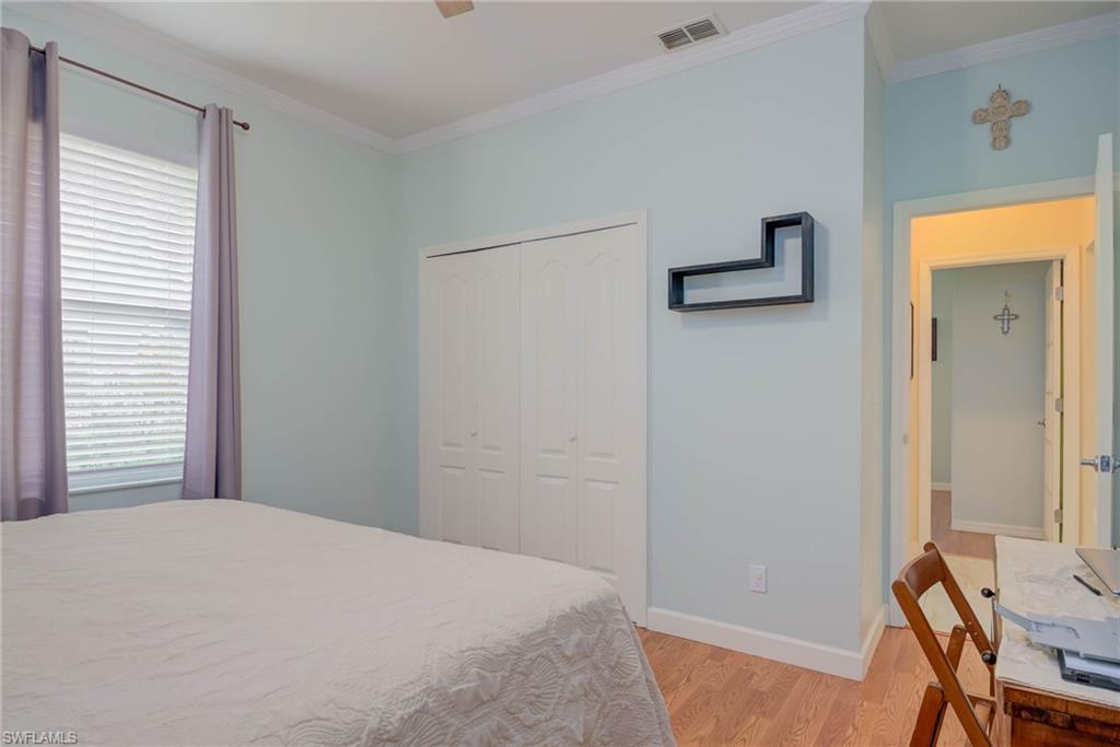 18370 Tulip Road Fort Myers, FL 33967 - Photo 18 of 30 a bedroom with a bed and a table in it