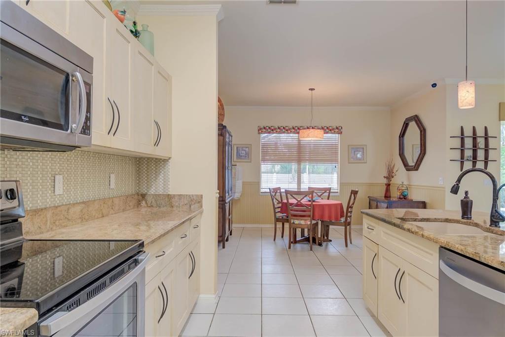 18370 Tulip Road Fort Myers, FL 33967 - Photo 10 of 30 a kitchen with a sink appliances and cabinets