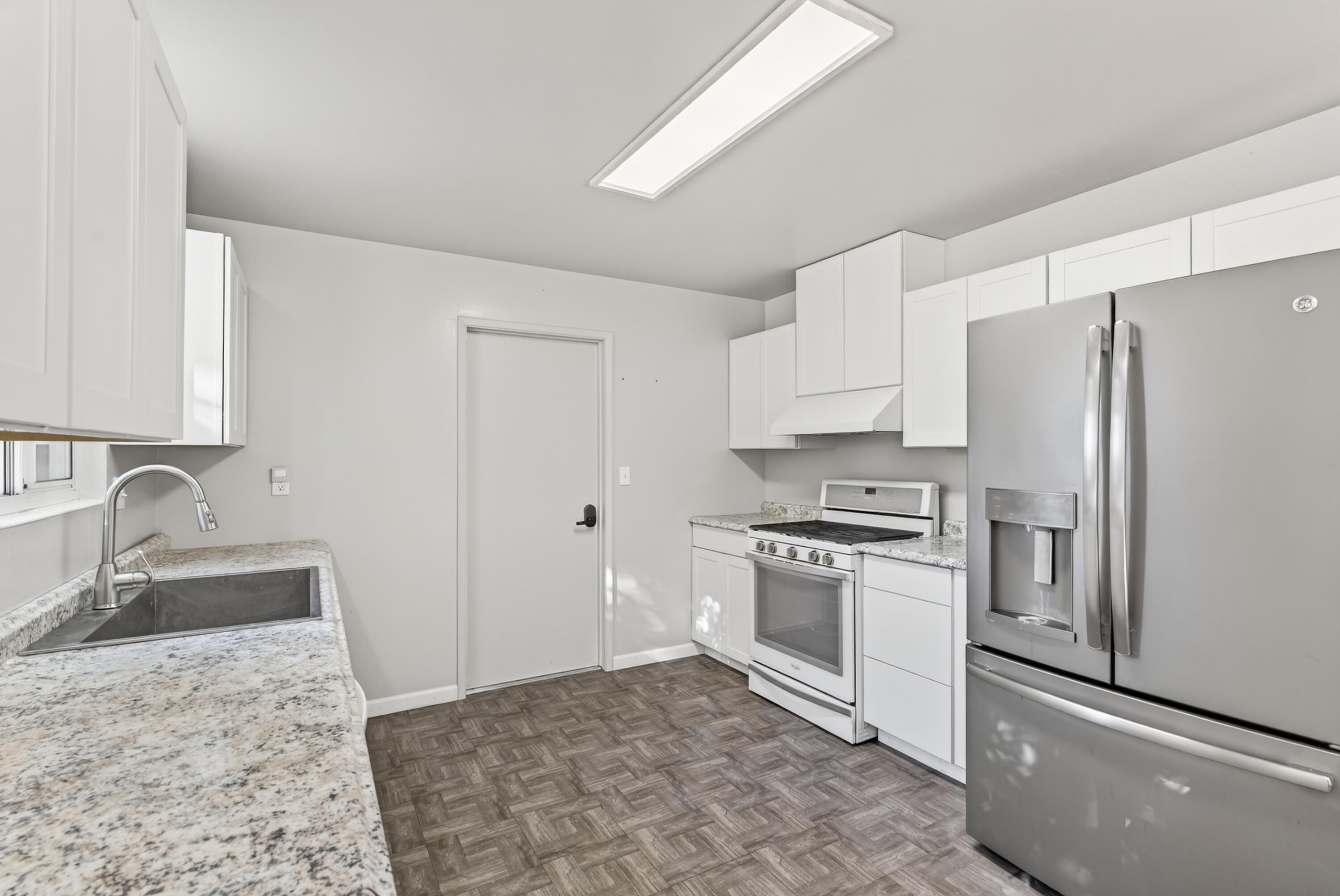 2068 Solar Way Redding, CA 96002 - Photo 12 of 36 a kitchen with granite countertop a refrigerator stove and sink