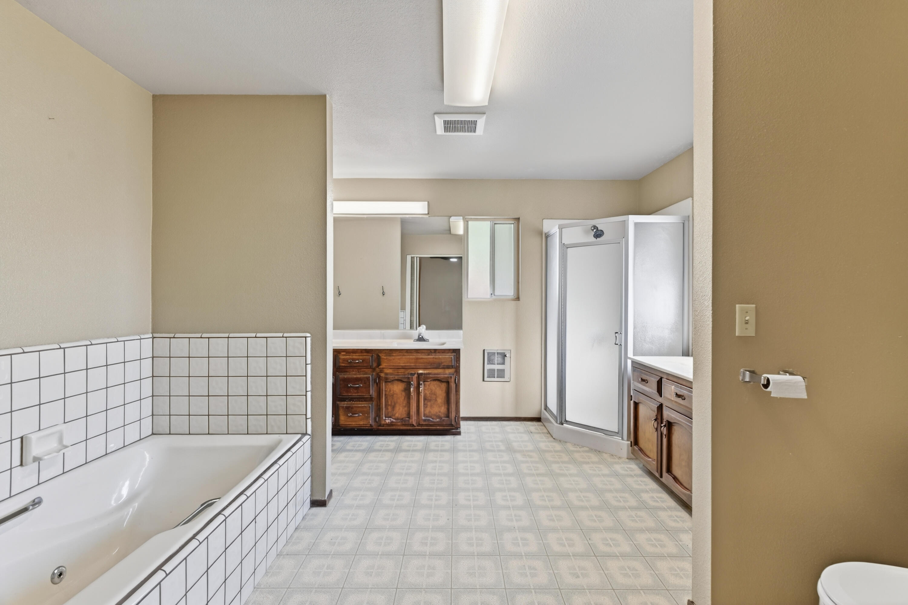 2068 Solar Way Redding, CA 96002 - Photo 17 of 36 a bathroom with a tub a sink a mirror and a shower