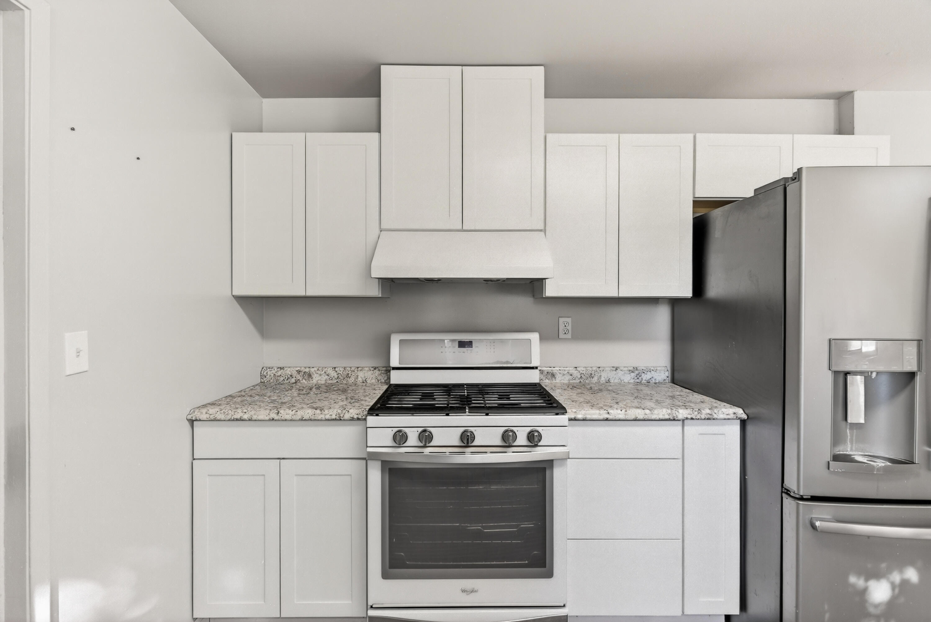 2068 Solar Way Redding, CA 96002 - Photo 10 of 36 a kitchen with granite countertop white cabinets and refrigerator