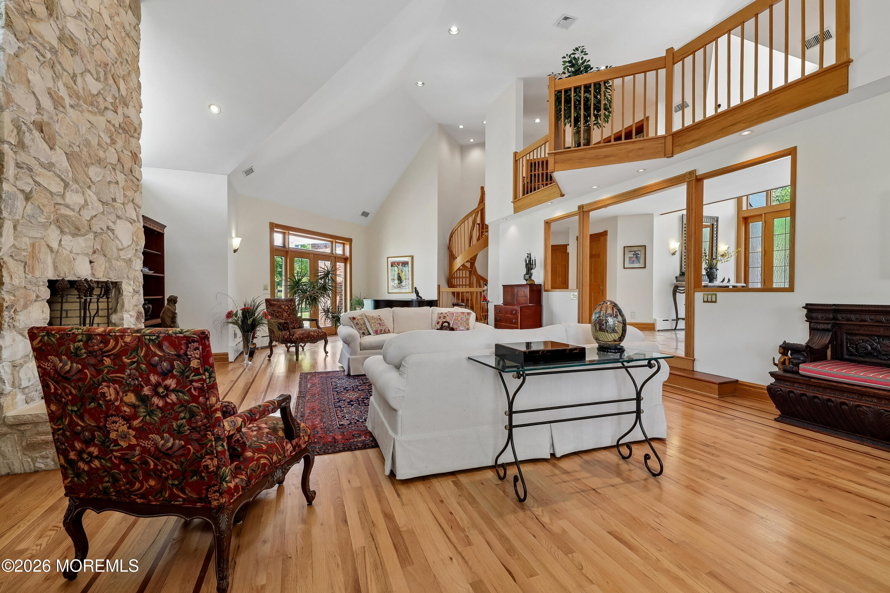 187 Hockhockson Road Colts Neck, NJ 07722 - Photo 12 of 55 a living room with furniture a fireplace and wooden floor