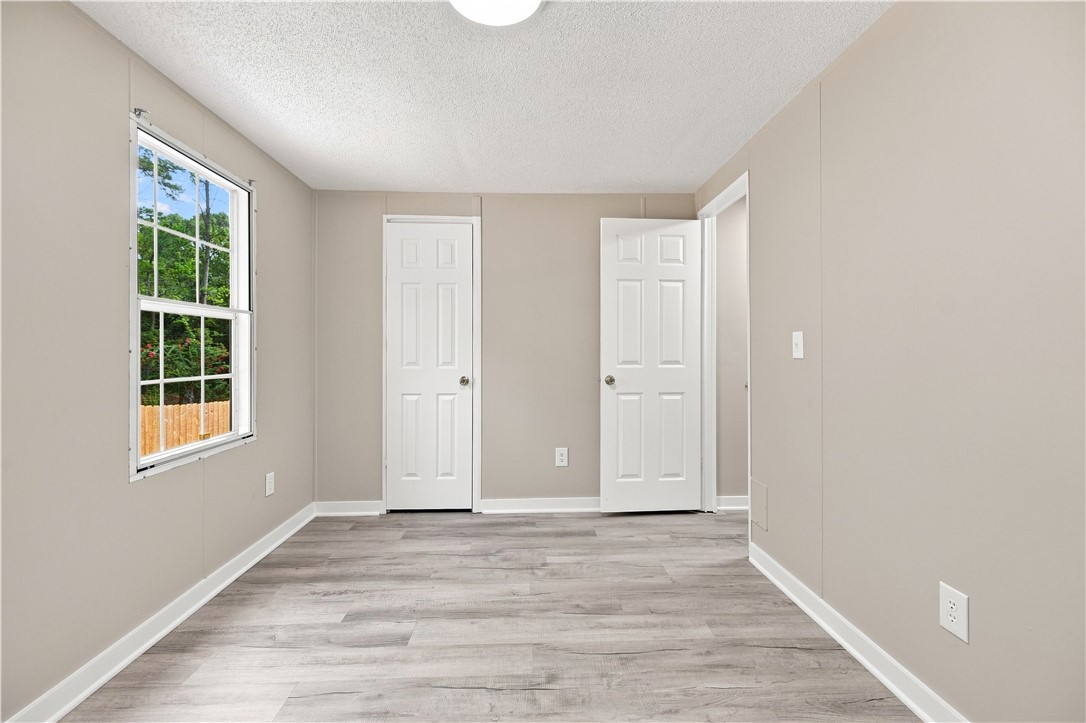213 Old River Road Pelzer, SC 29669 - Photo 19 of 27 Smooth wood-plank flooring pairs with a classic multi-pane window in this versatile secondary bedroom.
