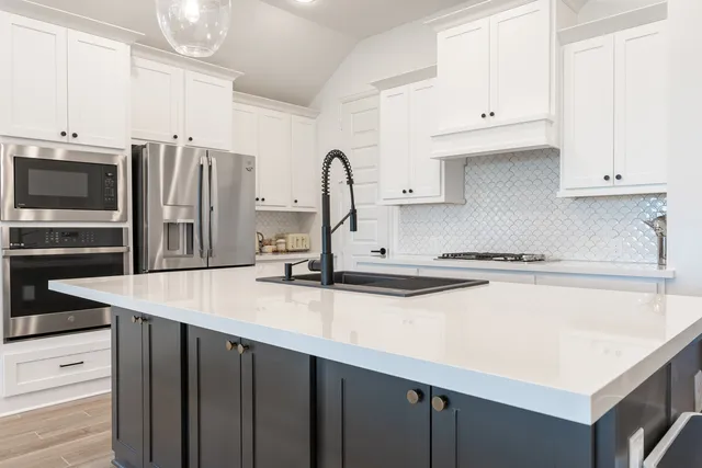 a kitchen with stainless steel appliances a sink and cabinets