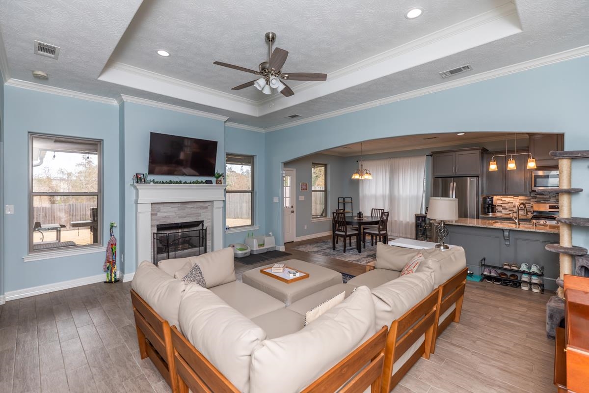 314 Long Leaf Street Silsbee, TX 77656 - Photo 5 of 31 a living room with fireplace furniture and a flat screen tv