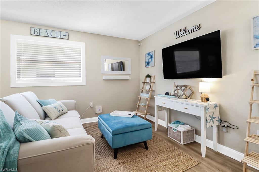 3325 Airport Road North, Unit G5 Naples, FL 34105 - Photo 3 of 8 Living area featuring baseboards and wood finished floors