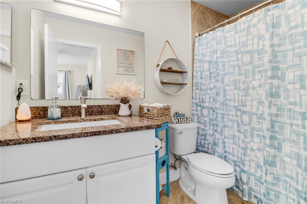 3325 Airport Road North, Unit G5 Naples, FL 34105 - Photo 6 of 8 Bathroom with vanity and curtained shower