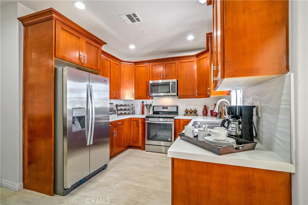 1101 North Maclay Avenue, Unit 1 San Fernando, CA 91340 - Photo 11 of 41 a kitchen with stainless steel appliances granite countertop a refrigerator stove and sink