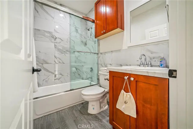 a living room with couch and wall paintings