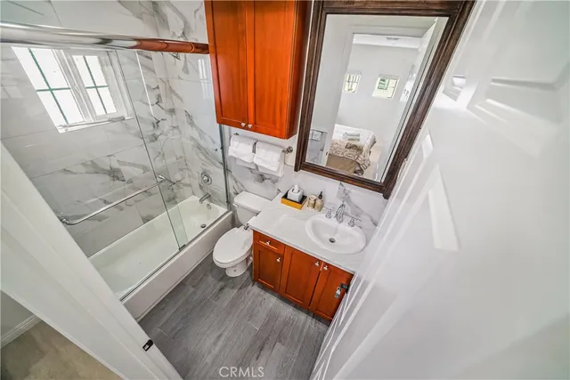 a bathroom with a sink a toilet and bathtub