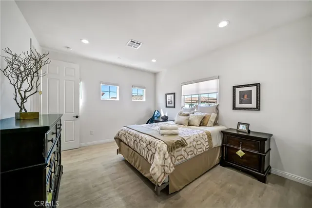 a bedroom with a bed and a view of bedroom