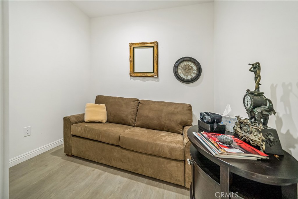 1101 North Maclay Avenue, Unit 1 San Fernando, CA 91340 - Photo 22 of 41 a living room with a couch and a wall painting