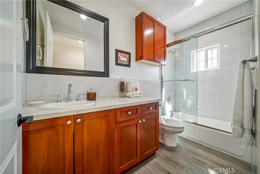 1101 North Maclay Avenue, Unit 1 San Fernando, CA 91340 - Photo 25 of 41 a bathroom with a double vanity sink toilet mirror and shower