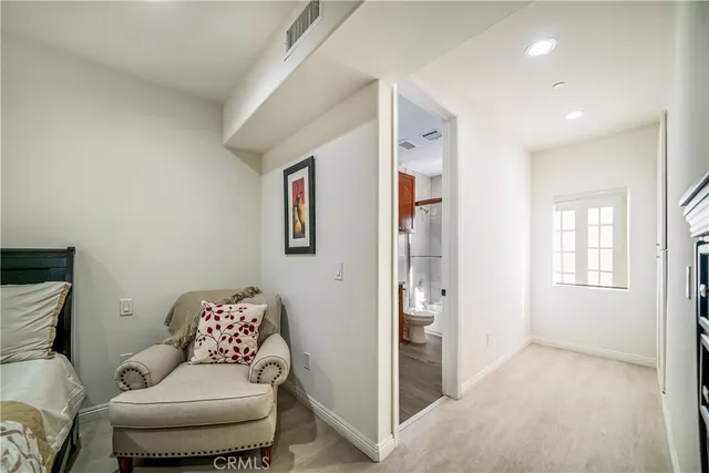 a bedroom with furniture and a wooden floor