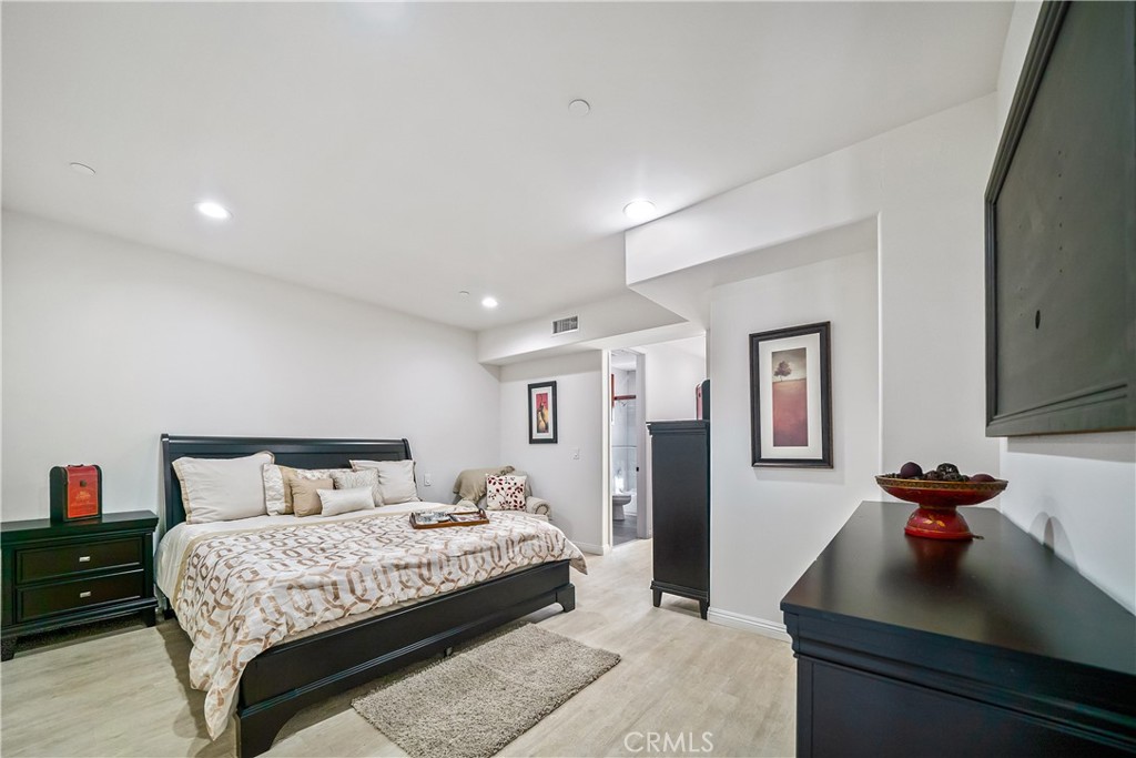 1101 North Maclay Avenue, Unit 1 San Fernando, CA 91340 - Photo 27 of 41 a bedroom with a bed and a dresser with the mirror