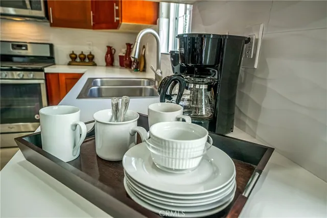 a kitchen with stainless steel appliances granite countertop a refrigerator stove and sink