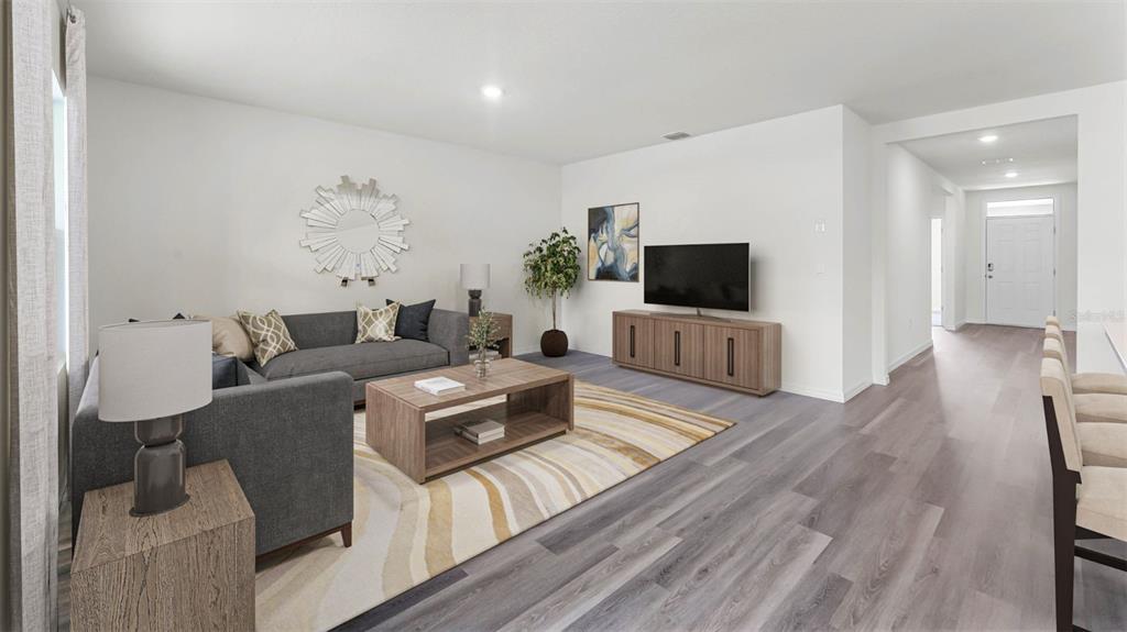 5233 Masser Road St. Cloud, FL 34772 - Photo 4 of 15 a living room with furniture flat screen tv and wooden floor