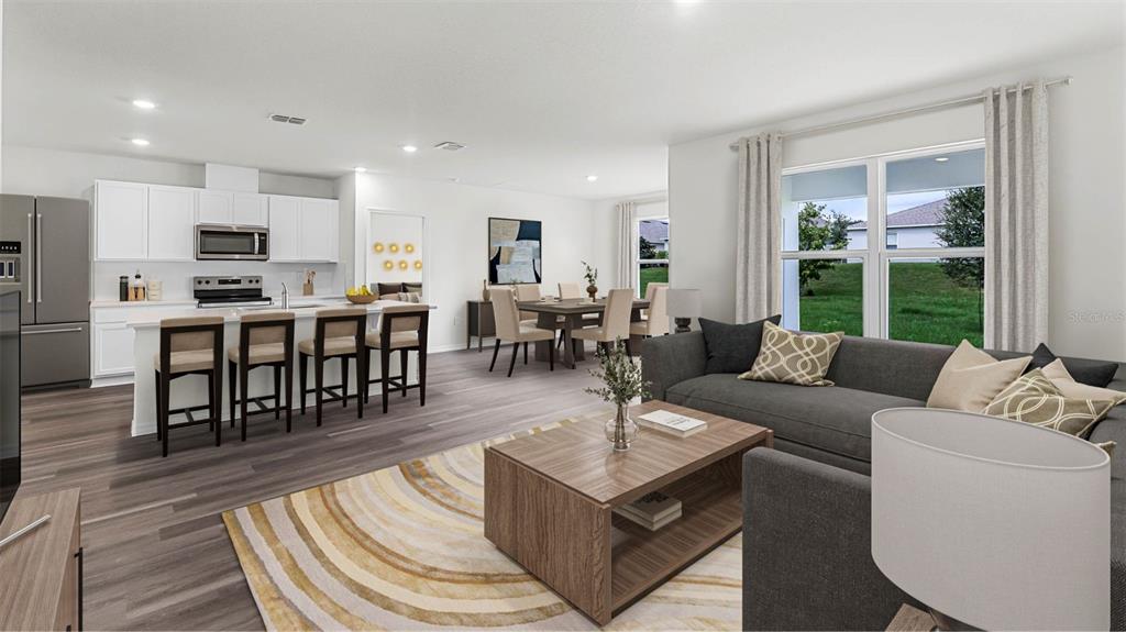 5233 Masser Road St. Cloud, FL 34772 - Photo 5 of 15 a living room with furniture a wooden floor and a large window