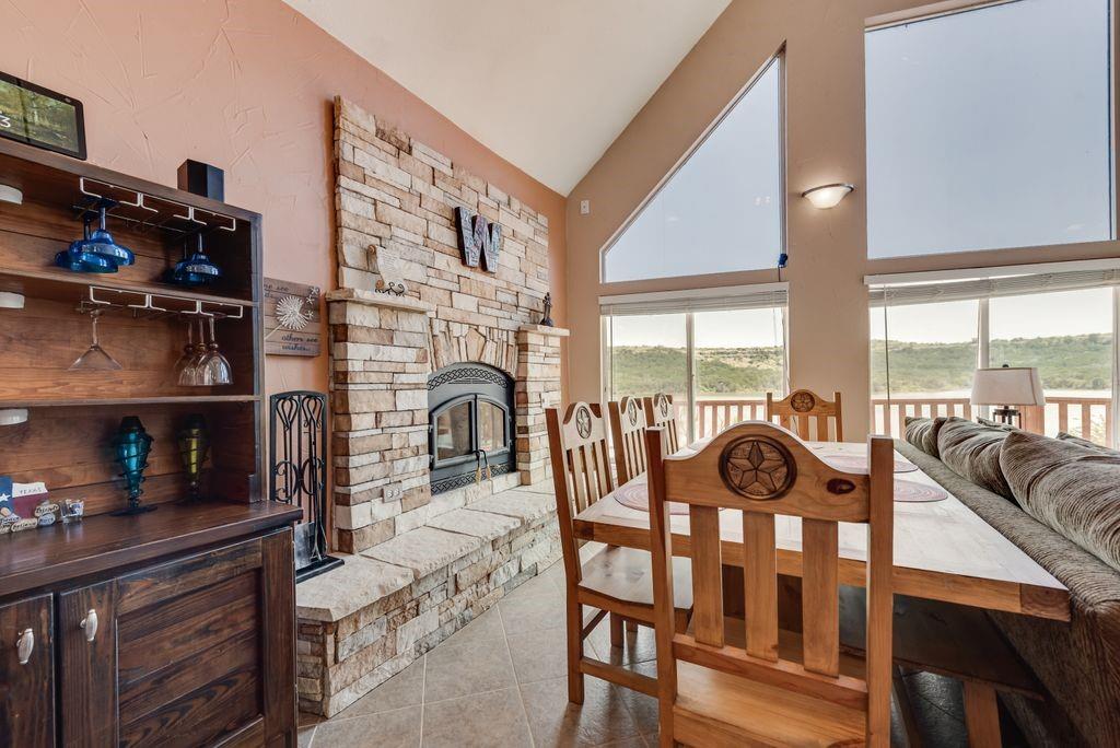 3617 Brandy Road Caddo, TX 76429 - Photo 8 of 40 Dining area featuring a fireplace, and high vaulted ceiling