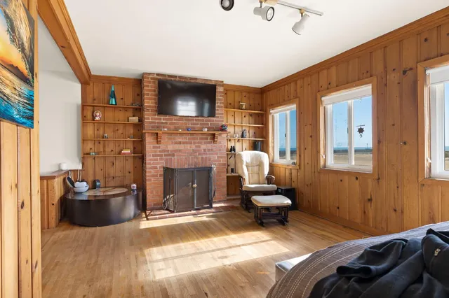 a bedroom with furniture and a fireplace