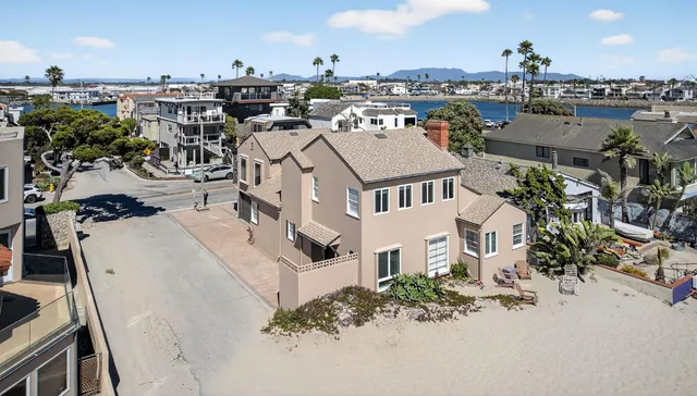 an aerial view of a house with a yard and lake view