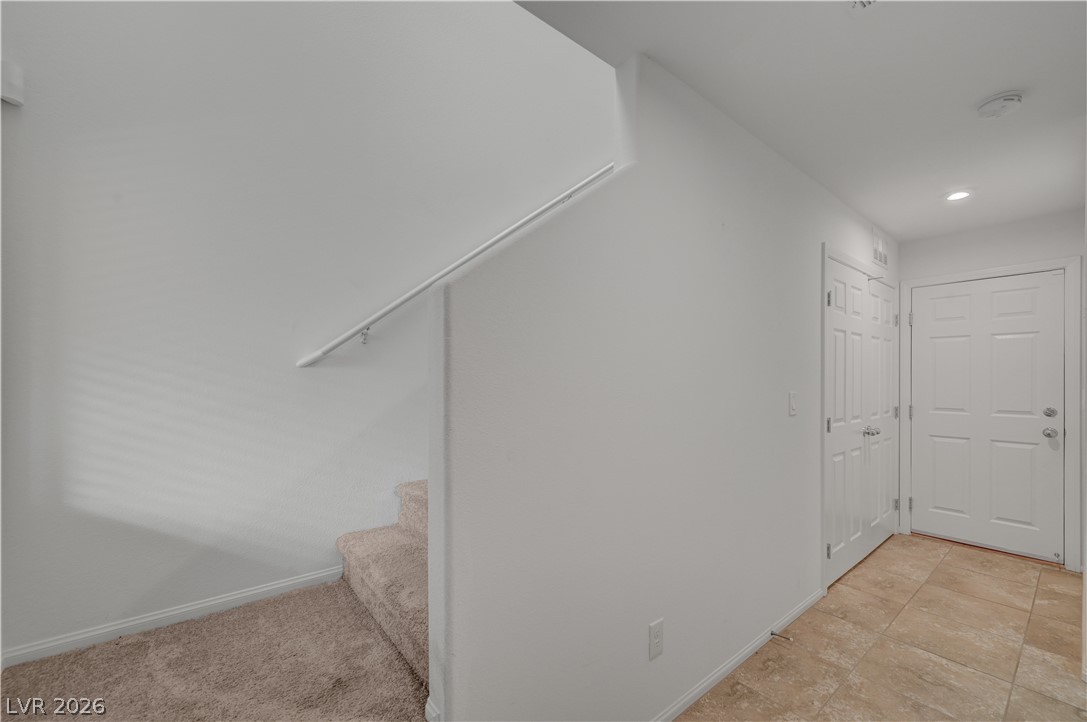 1287 Raritan Place Henderson, NV 89002 - Photo 9 of 21 A welcoming entryway offers a tiled floor and access to a carpeted staircase.