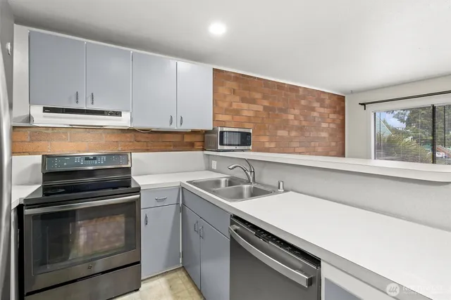 a kitchen with a sink stove and cabinets