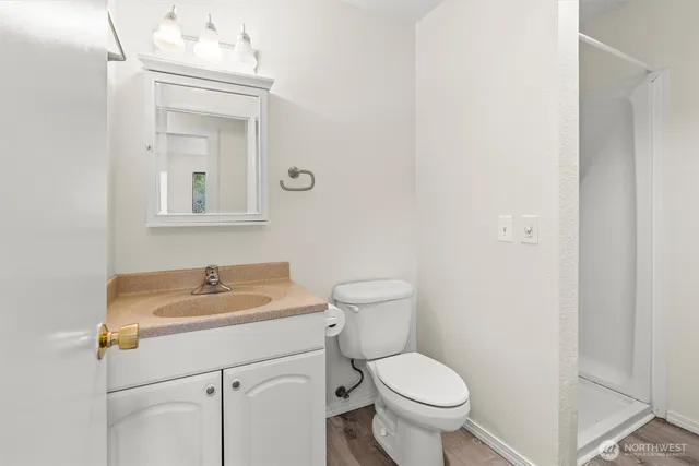 a bathroom with a sink toilet and mirror