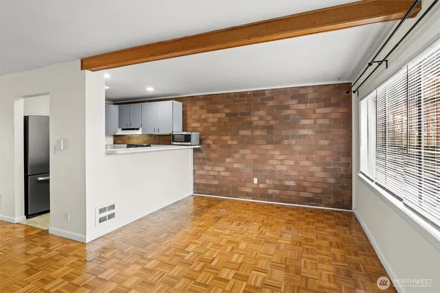 a view of a kitchen with wooden floor and a ceiling fan
