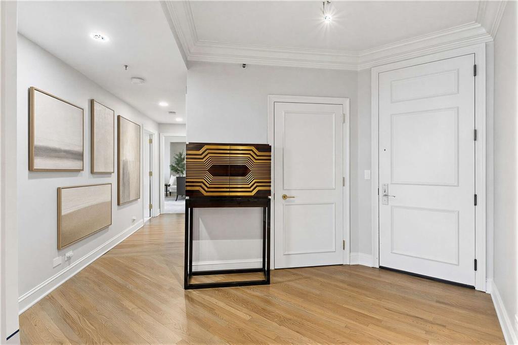 2660 Peachtree Road Northwest, Unit 34F Atlanta, GA 30305 - Photo 27 of 57 a kitchen with a refrigerator and wooden floor