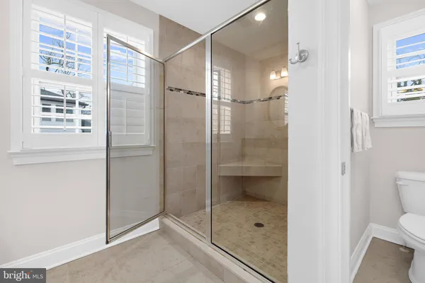 a bathroom that has a glass shower door