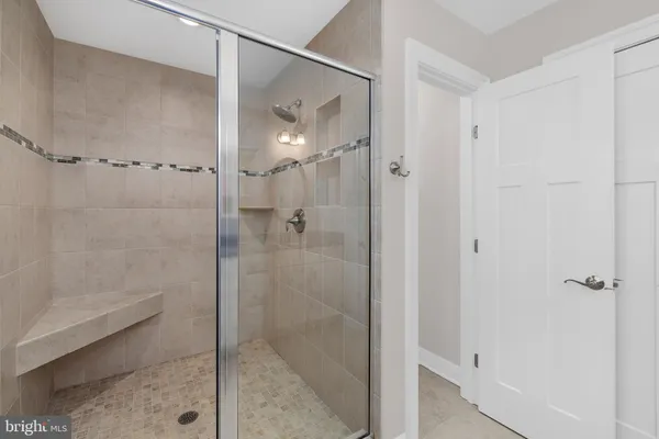 a bathroom with a granite countertop double vanity sink and a mirror
