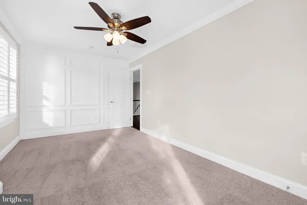a view of walk in closet with wooden floor and window