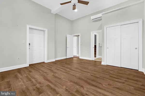 a view of empty room with wooden floor