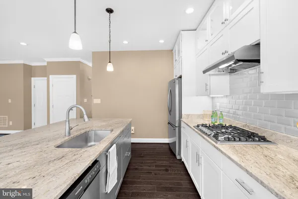 a kitchen with sink a stove and refrigerator