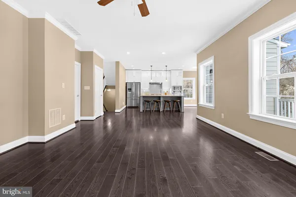 a view of a workspace with wooden floor and furniture
