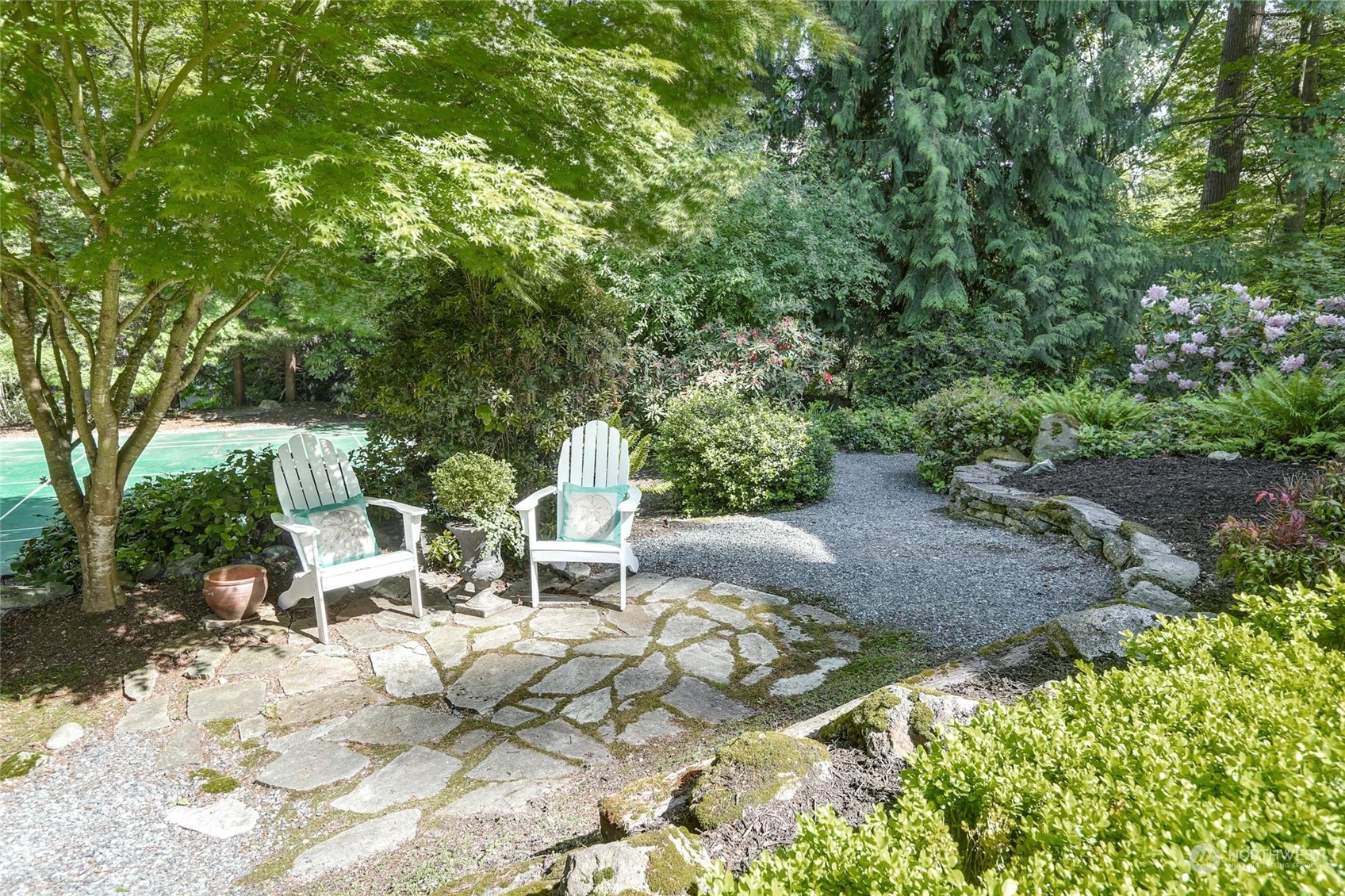 15629 Cascadian Way Bothell, WA 98012 - Photo 2 of 40 a view of a patio with table and chairs and potted plants with large trees