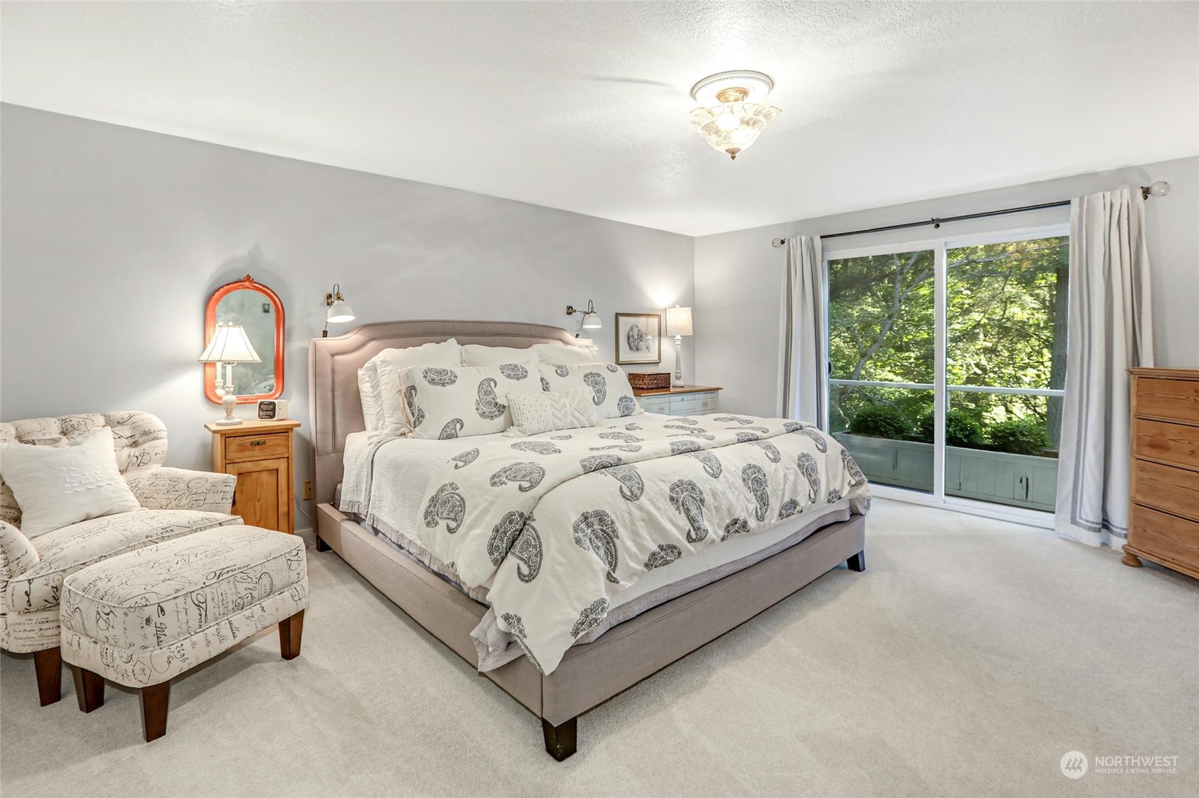 15629 Cascadian Way Bothell, WA 98012 - Photo 22 of 40 a spacious bedroom with a bed lamp and a large window