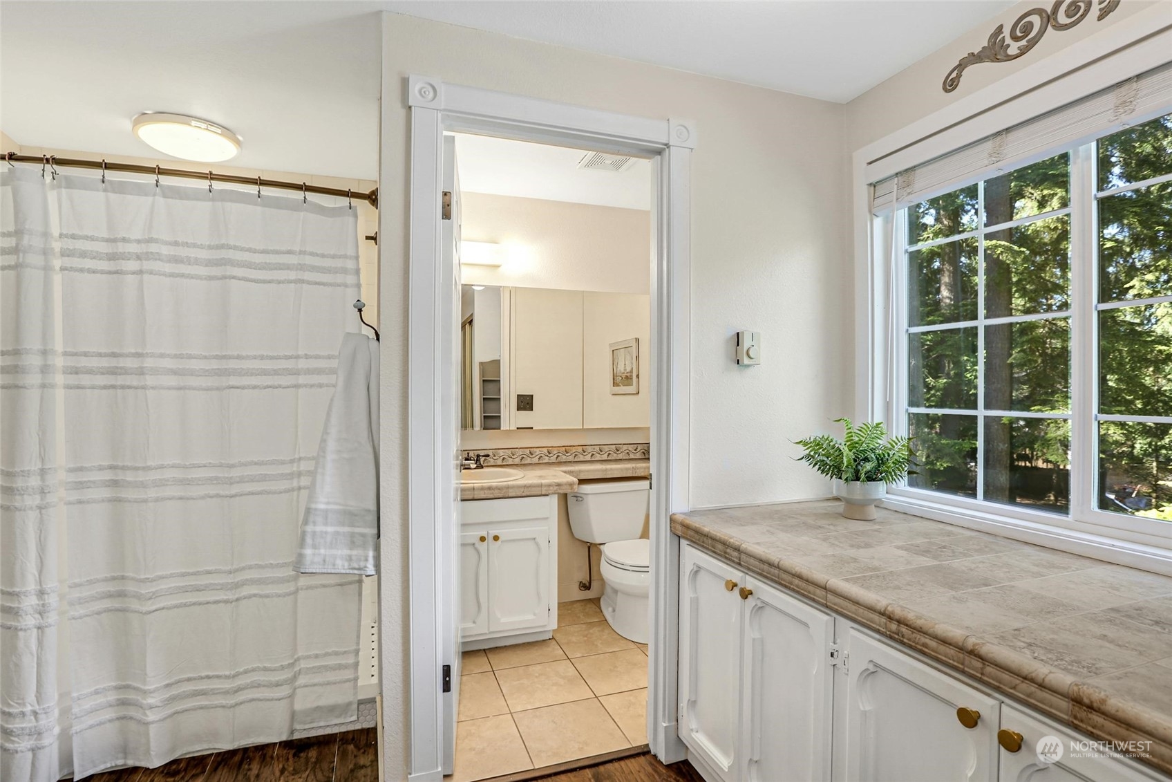 15629 Cascadian Way Bothell, WA 98012 - Photo 24 of 40 a bathroom with a granite countertop sink a mirror and a shower