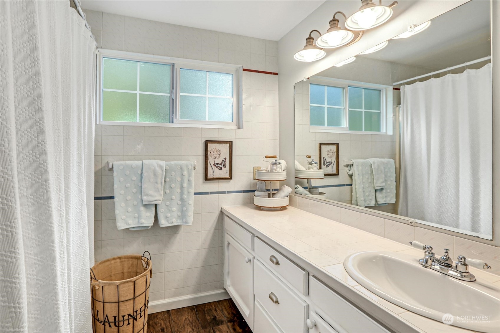 15629 Cascadian Way Bothell, WA 98012 - Photo 26 of 40 a en suite bathroom with a double vanity sink a mirror and a toilet