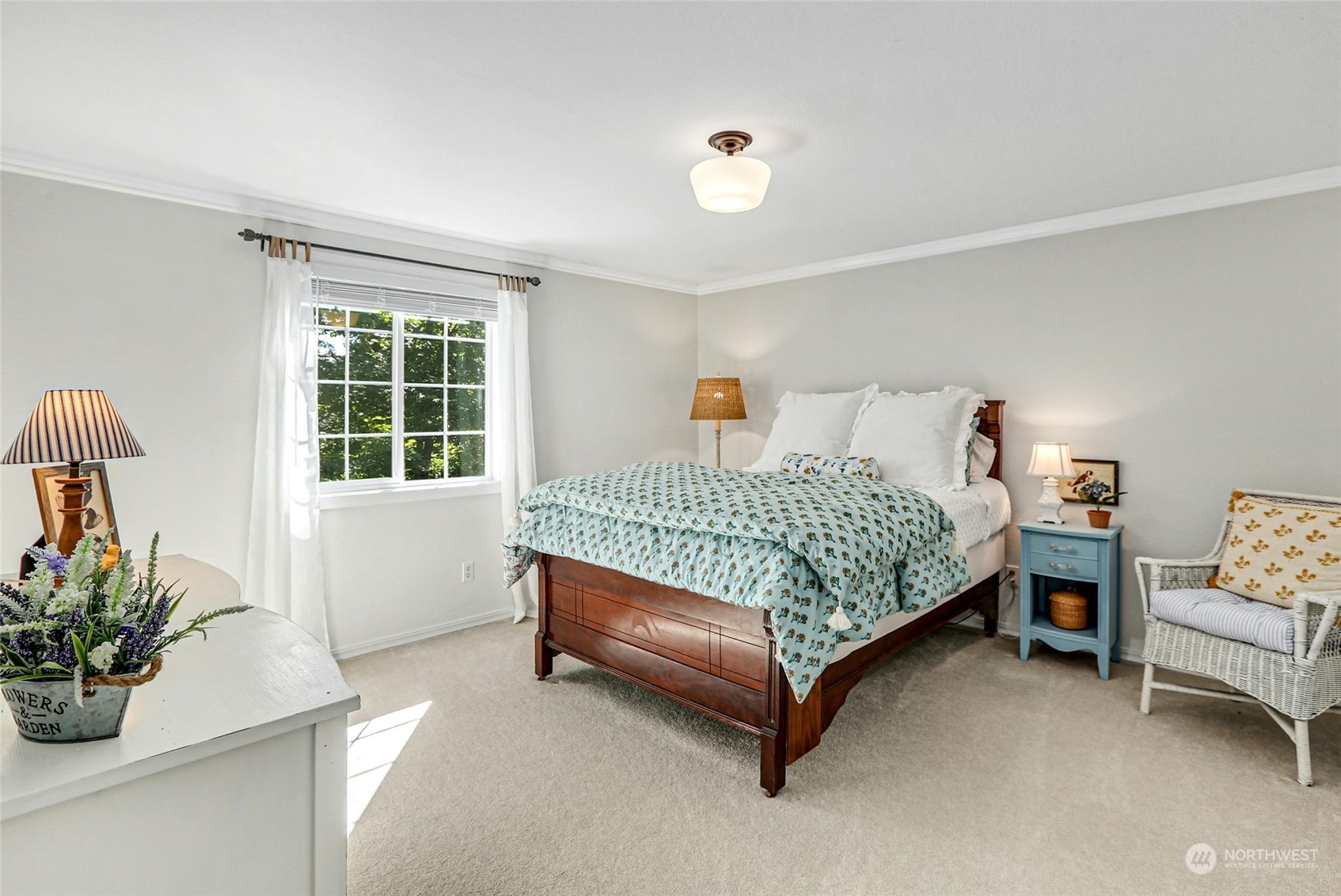 15629 Cascadian Way Bothell, WA 98012 - Photo 28 of 40 a bedroom with a bed table flowerpot and window
