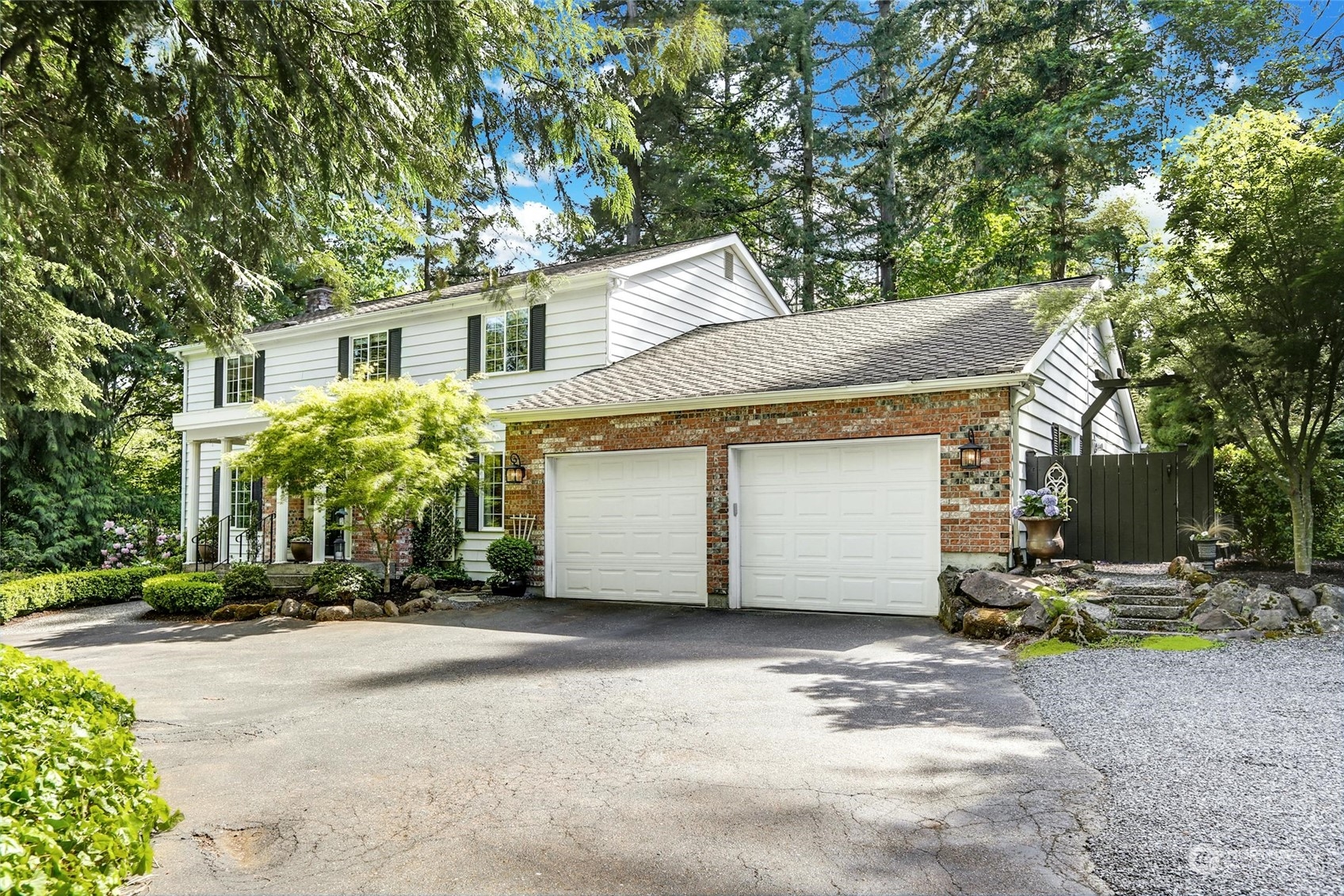15629 Cascadian Way Bothell, WA 98012 - Photo 3 of 40 a view of a white house with a tree and plants