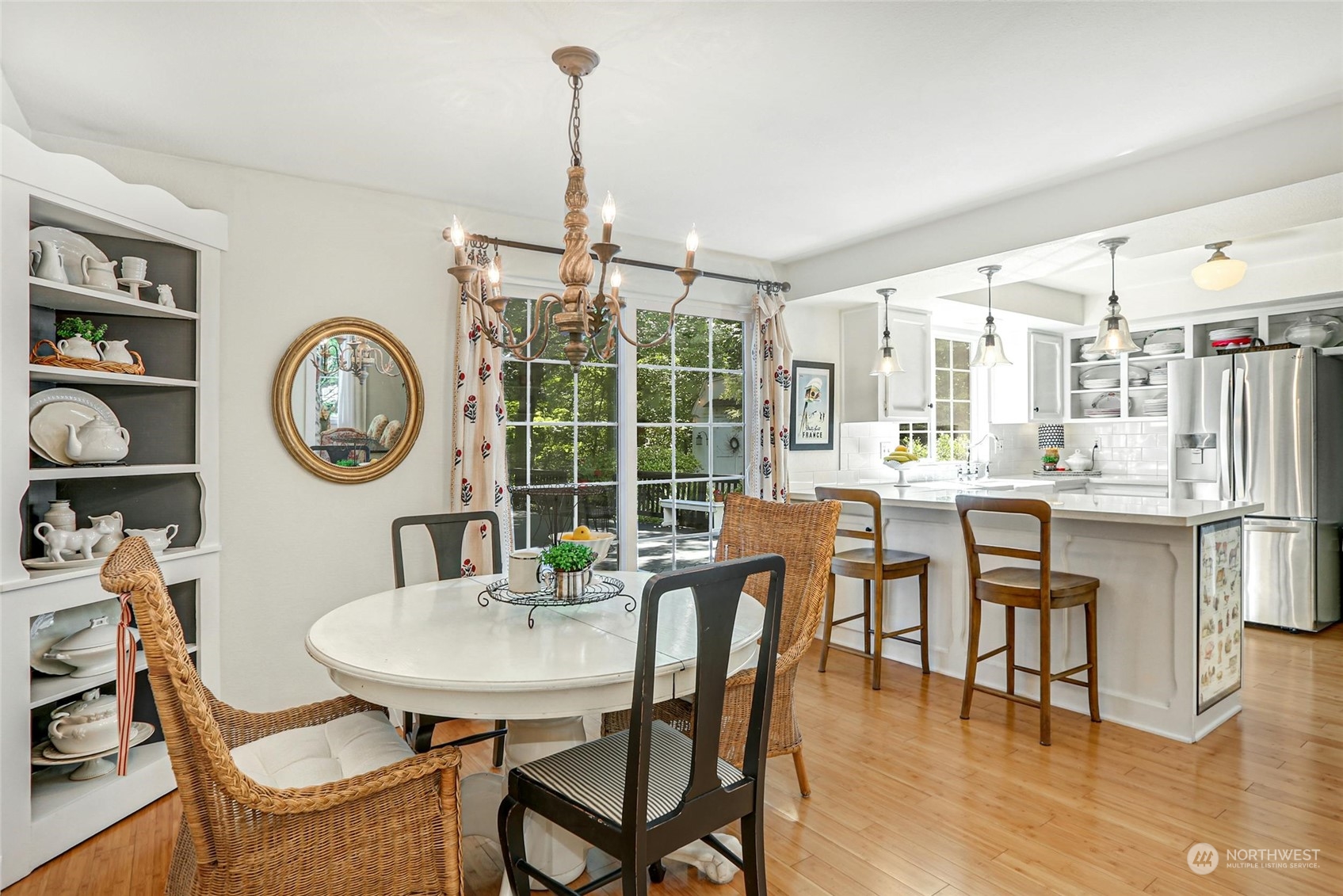 15629 Cascadian Way Bothell, WA 98012 - Photo 10 of 40 a dining room with furniture a chandelier and wooden floor