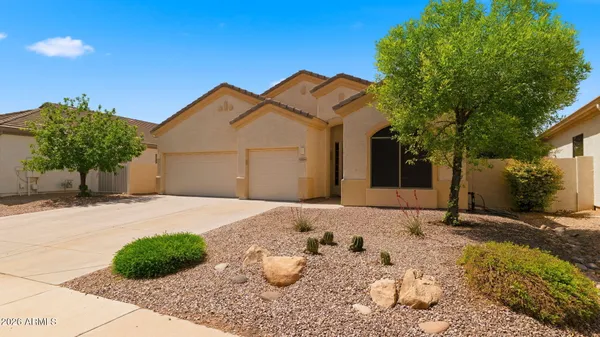 a front view of a house with a yard and garage