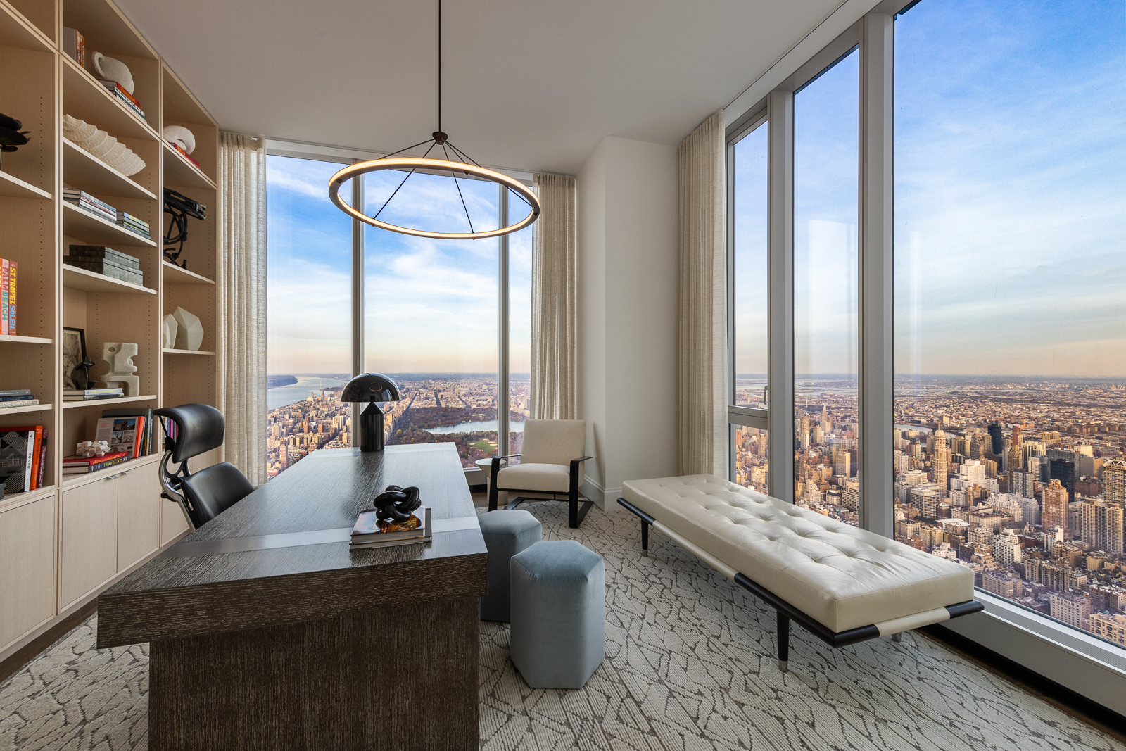 217 West 57th Street, Unit 121 Manhattan, NY 10019 - Photo 4 of 21 a living room with furniture and floor to ceiling windows