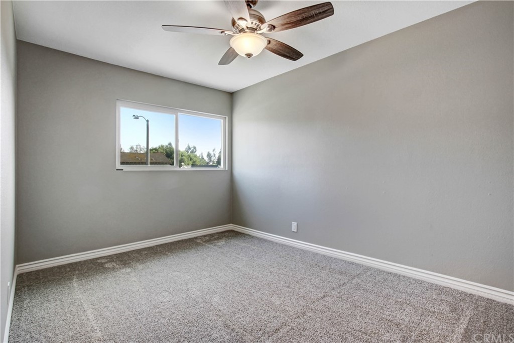 550 Termino Avenue Corona, CA 92879 - Photo 11 of 20 an empty room with a window and a fan