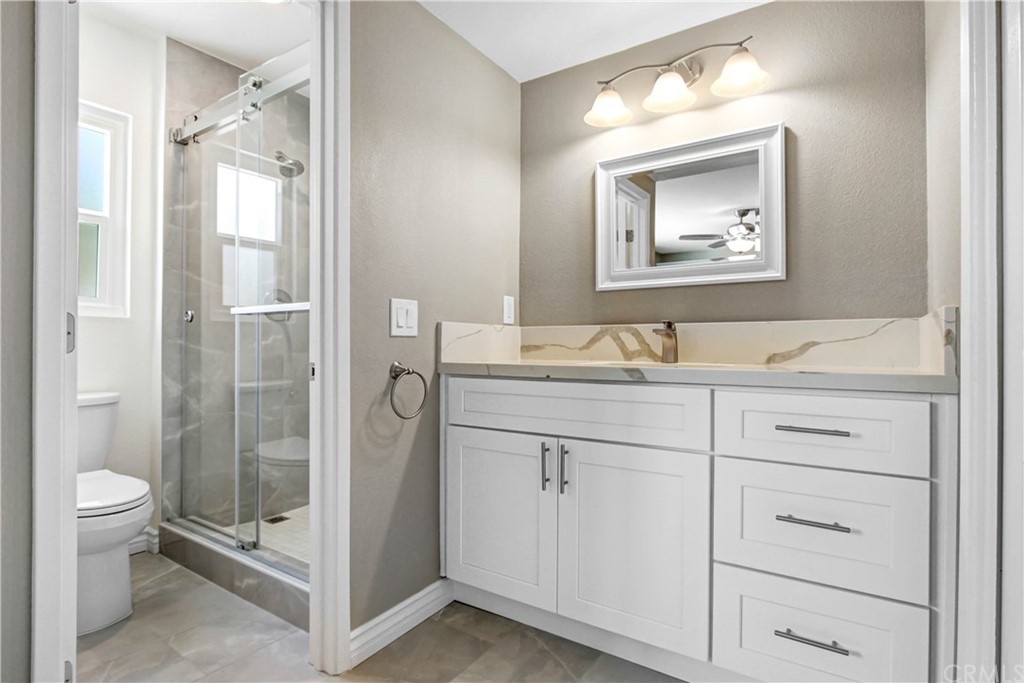 550 Termino Avenue Corona, CA 92879 - Photo 14 of 20 a bathroom with a granite countertop sink toilet and shower